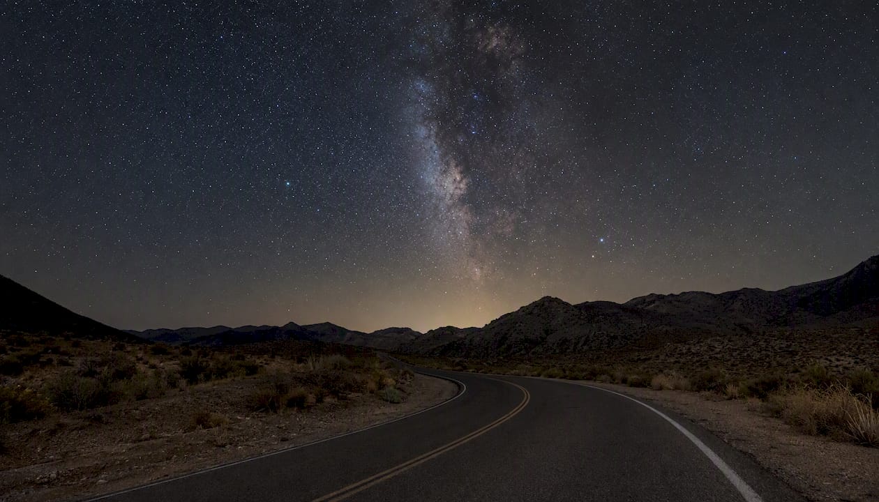 Dark Pinto Basin Road under starry sky at night