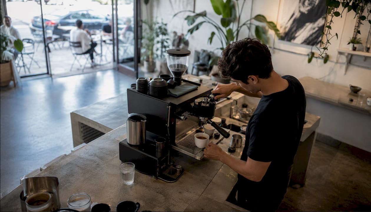 Barista pouring espresso in LA coffee shop