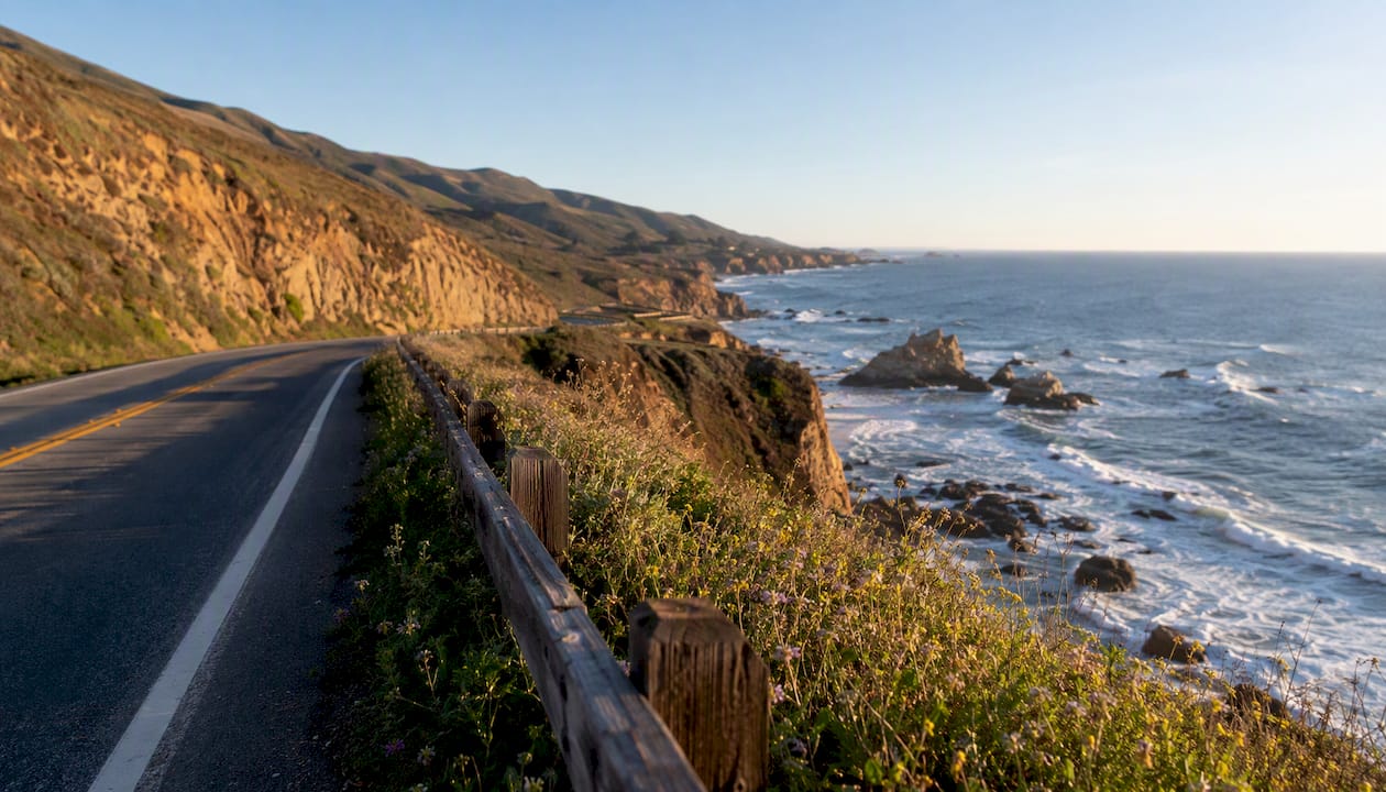 Scenic Pacific Coast Highway curve by ocean cliffs