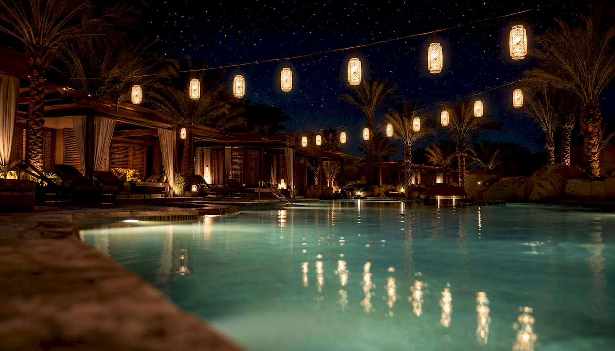 Resort pool deck with string lights at night