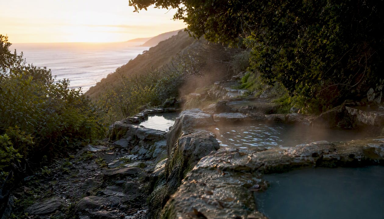 Terraced hot spring pools with coastal view