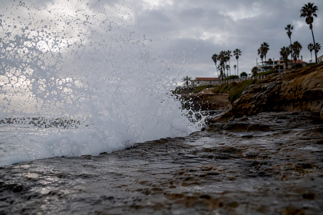 Sneaker wave crashing on rocky San Diego shore