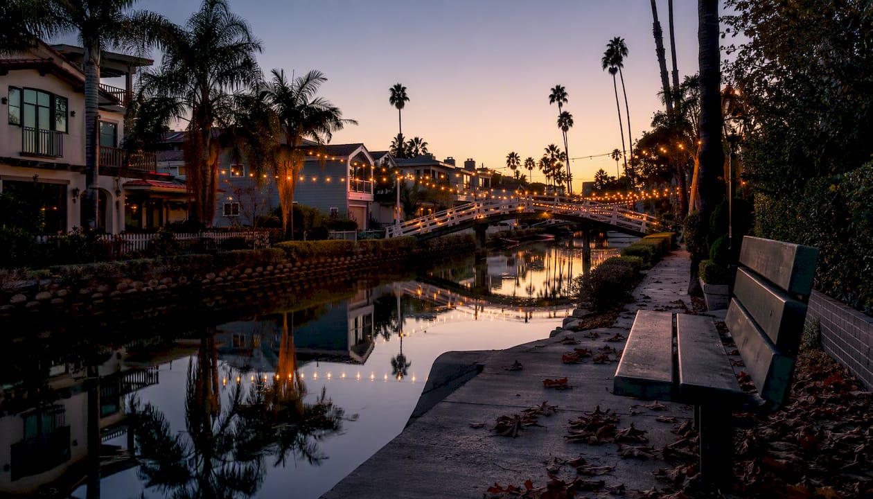 Naples canal at golden hour with string lights