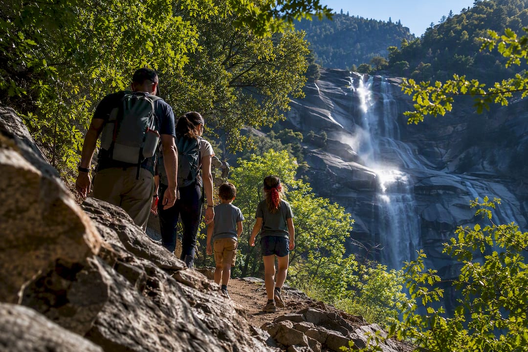 Family hiking toward a Los Angeles waterfall