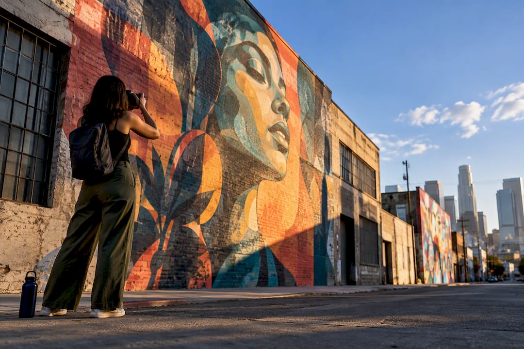 Visitor photographing a massive Arts District mural