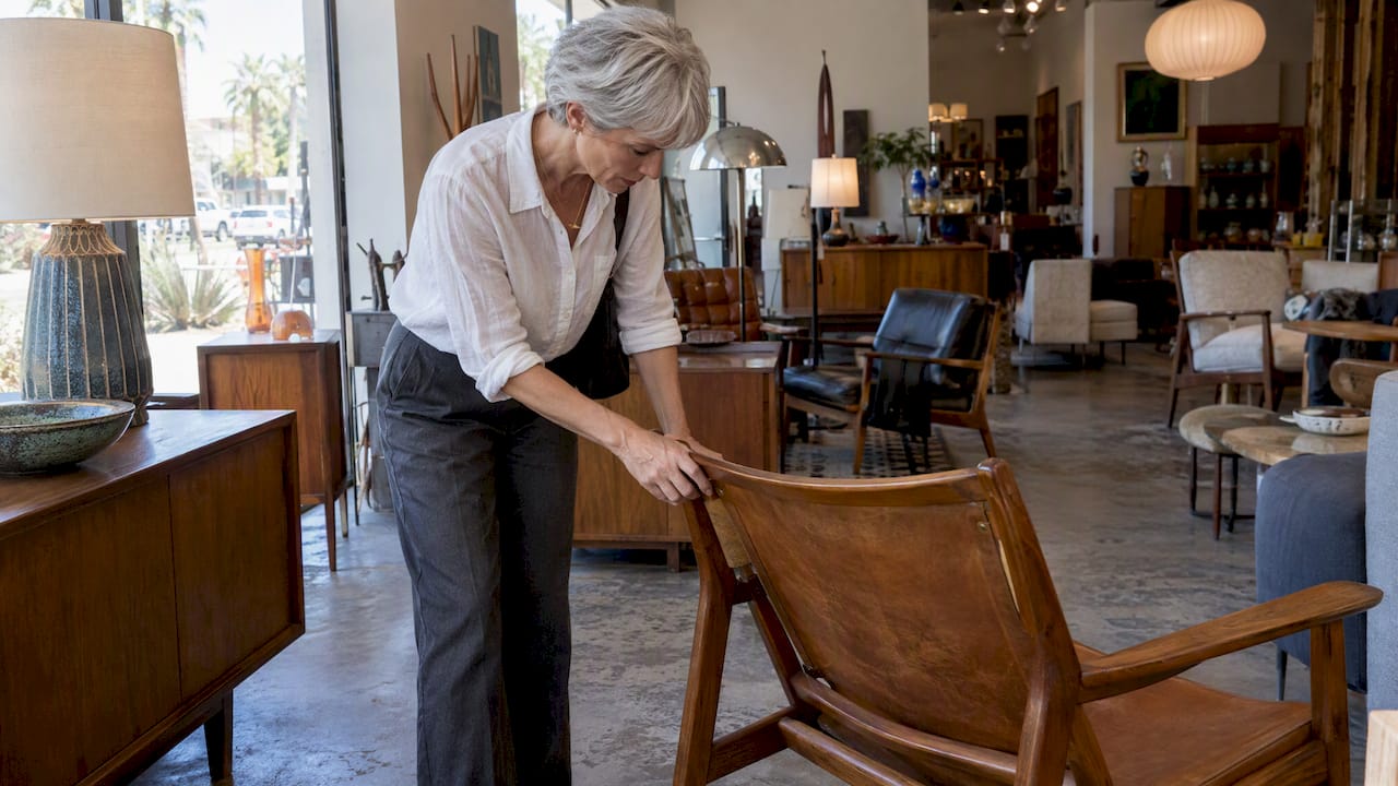 Shopper examining vintage mid-century furniture
