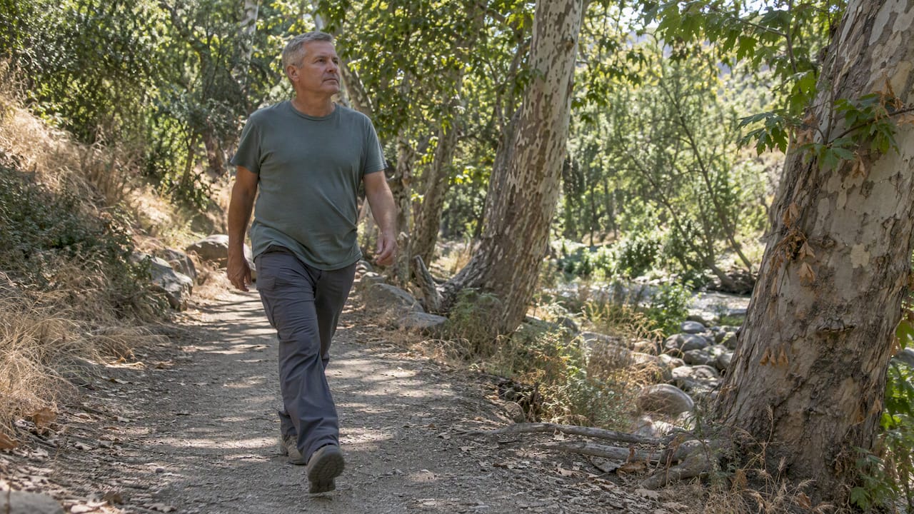 Walker on a shaded Arroyo Seco path