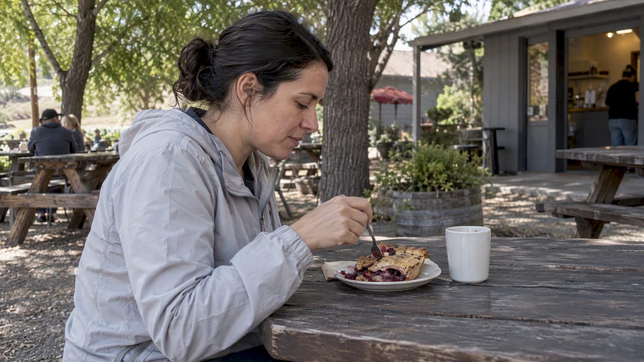 Visitor eating pie at Wynola outdoor seating